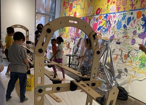 A child works on a constructed toy. 